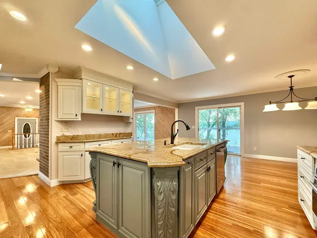 a living room with fireplace furniture and a large window