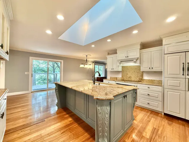a kitchen with stainless steel appliances granite countertop a sink and cabinets