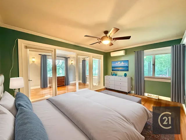 a view of a swimming pool with lawn chairs under an umbrella