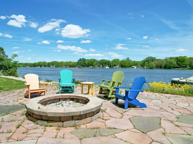 a living room with stainless steel appliances kitchen island granite countertop a sink and a cabinets