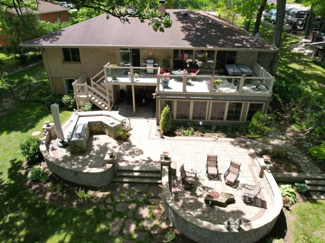 a large kitchen with stainless steel appliances kitchen island granite countertop a large counter top and a stove