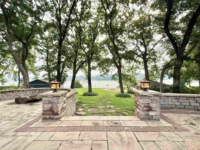 a view of a hallway with wooden floor and a living room