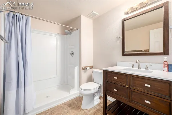a bathroom with a toilet a sink and a mirror