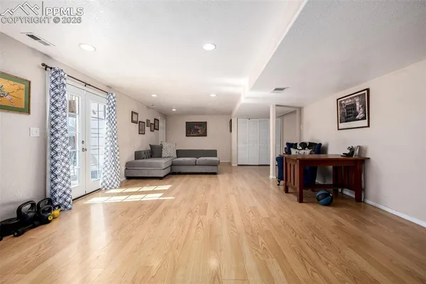 a living room with furniture and a wooden floor