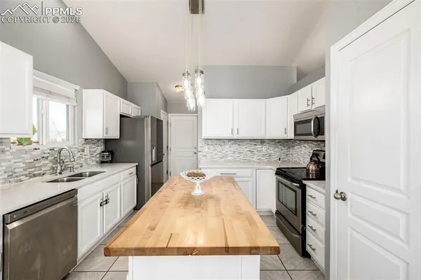 a kitchen with stainless steel appliances granite countertop a sink and cabinets