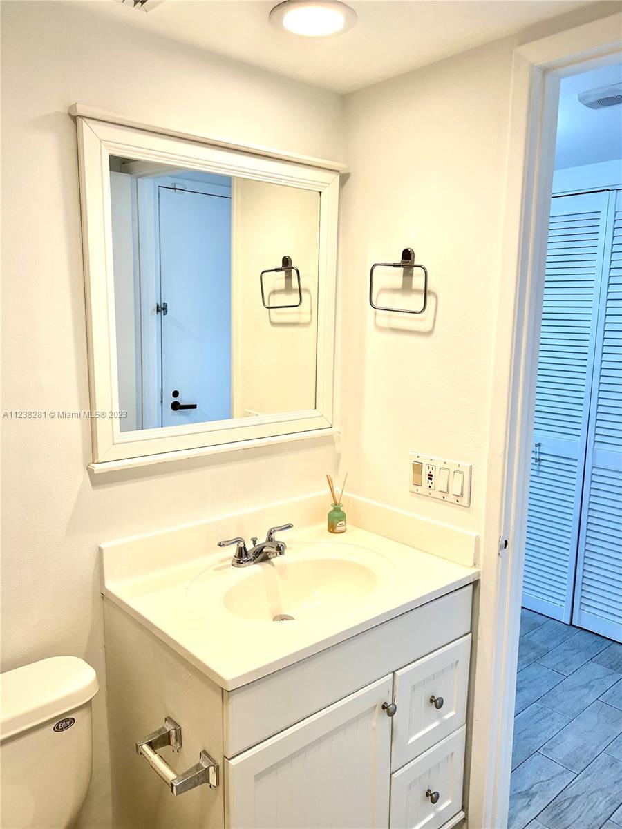 520 Brickell Key Drive, Unit A917 Miami, FL 33131 - Photo 11 of 12 a bathroom with a sink a toilet and a mirror