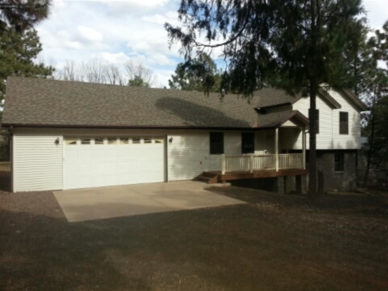 6243 Sutter Drive Lakeside, AZ 85929 - Photo 1 of 5 a front view of a house with a garden and trees
