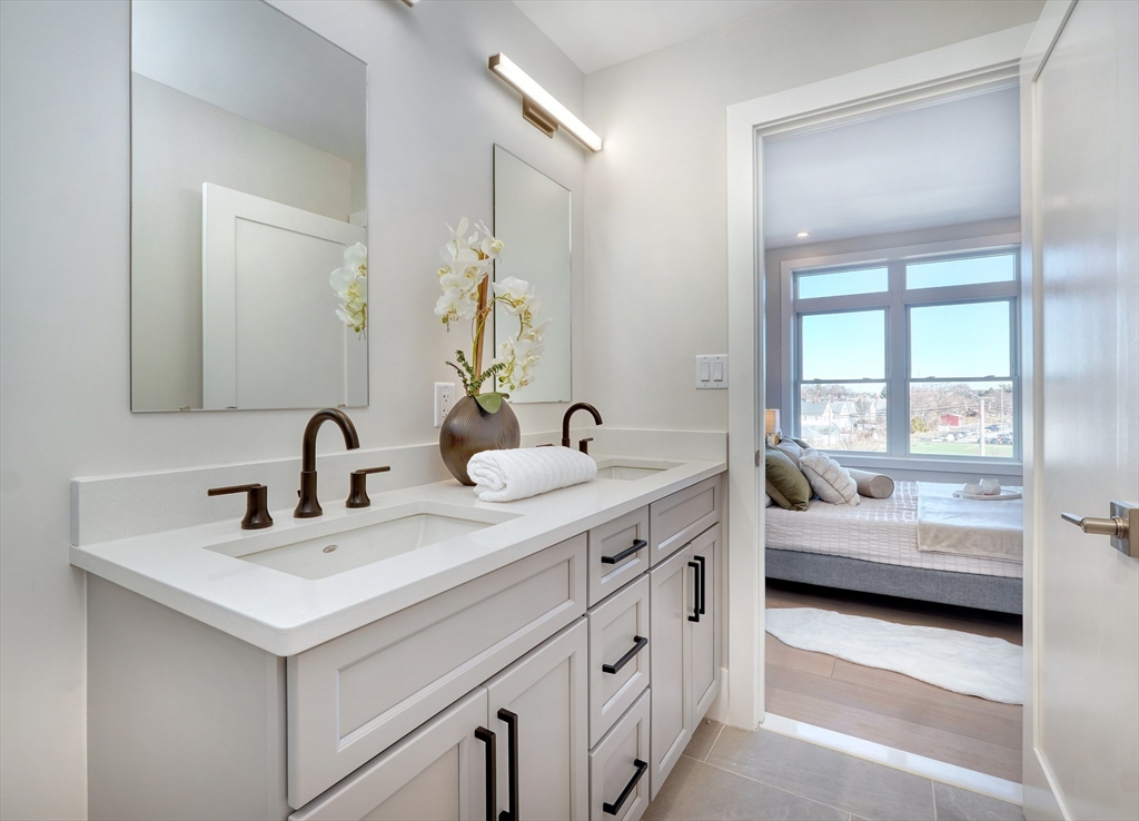 62 Foundry Street, Unit 506 Wakefield, MA 01880 - Photo 27 of 42 a en suite bathroom with double sink and a large mirror