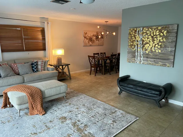 a living room with furniture rug and window