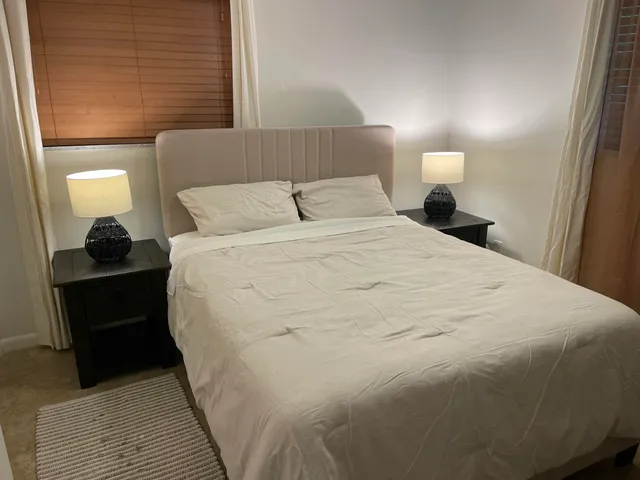 a large white bed in a small room