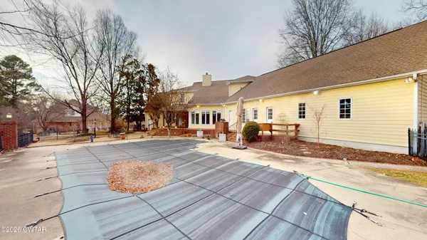 an aerial view of a house with a yard and outdoor seating