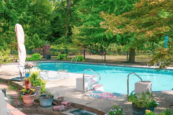 a view of a house with swimming pool and sitting area