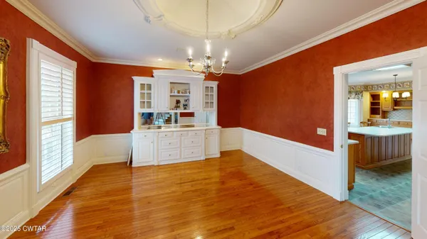 a large white kitchen with a large window