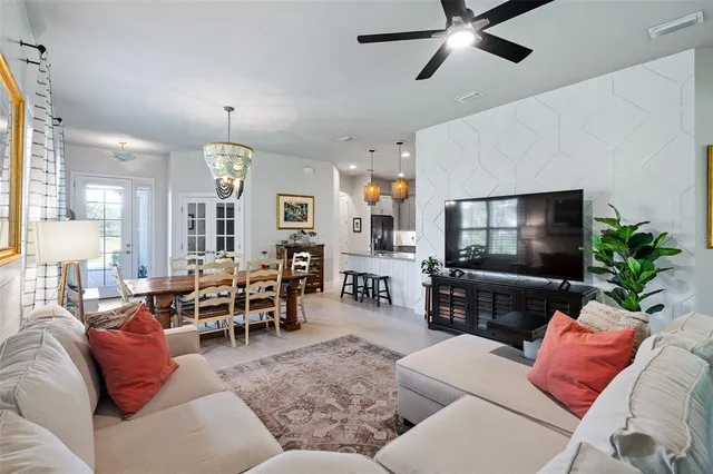 a living room with furniture and a flat screen tv with wooden floor