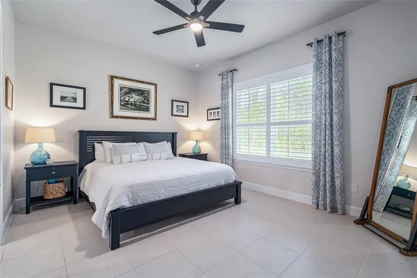 a bedroom with a bed and a large window