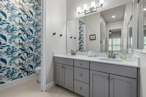 a bathroom with a double vanity sink and a mirror