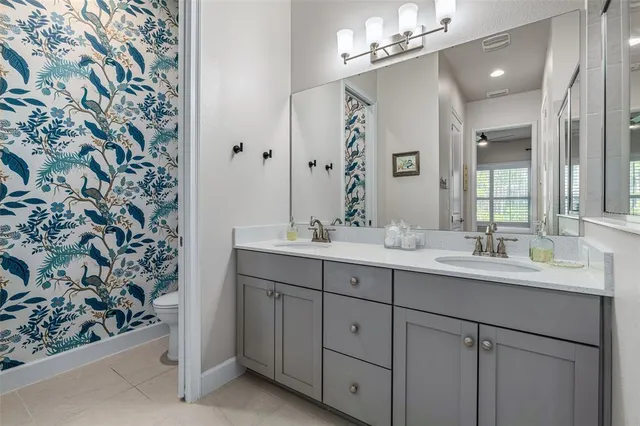 a bathroom with a double vanity sink and a mirror
