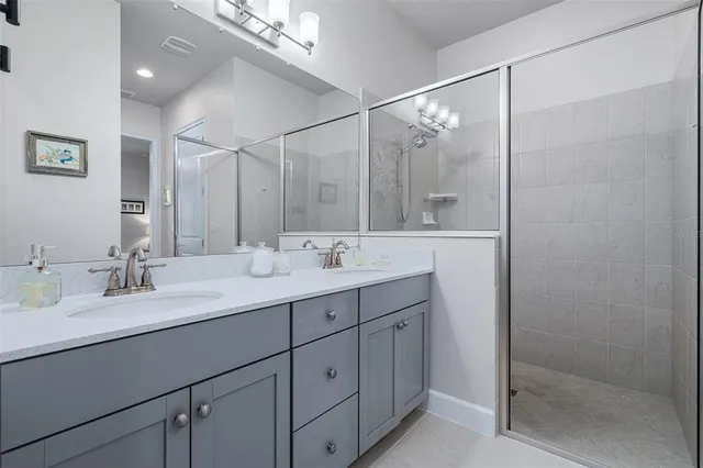 a bathroom with a double vanity sink and mirror