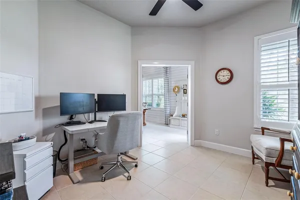 a view of a workspace with furniture and a window
