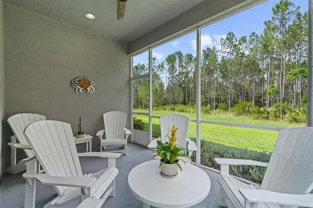 a view of a porch with furniture and a yard