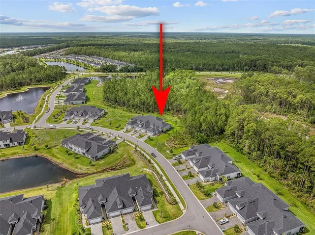 an aerial view of residential houses with outdoor space and swimming pool