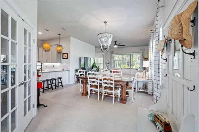 a view of a dining room with furniture and chandelier