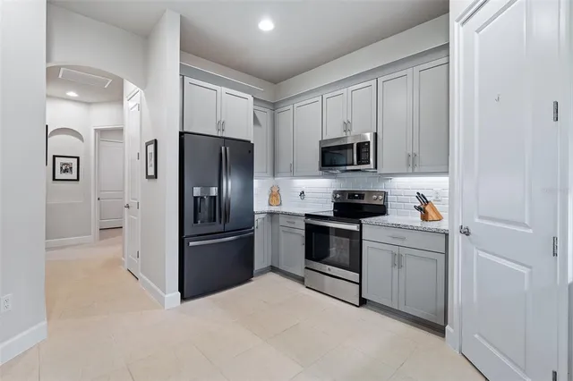a kitchen with a refrigerator stove and microwave