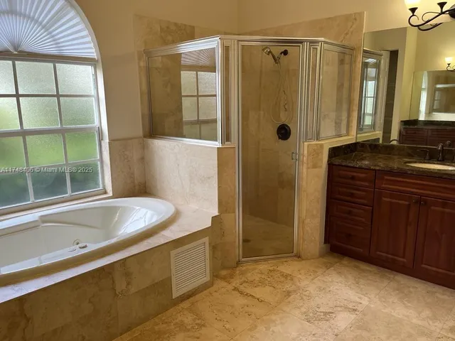 a bathroom with a bathtub and a shower