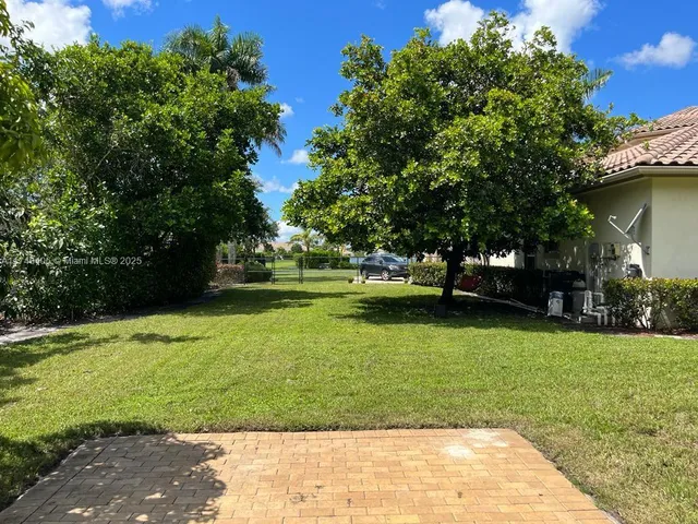 a view of a house with a yard and sitting area
