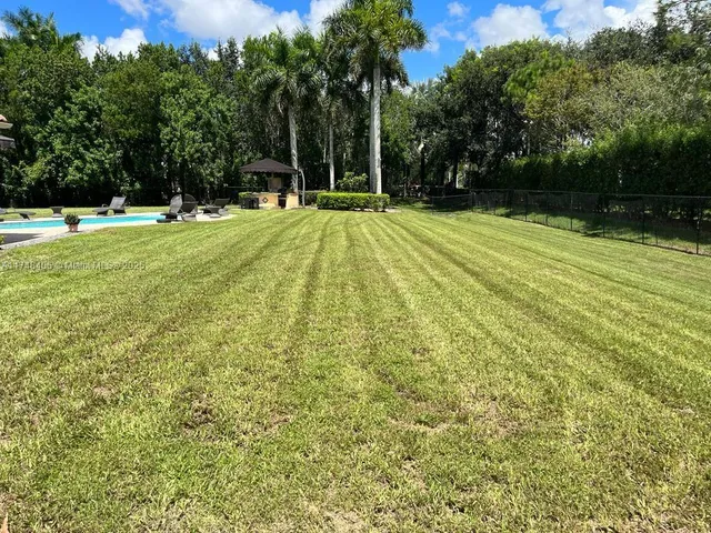 a view of a backyard with swimming pool
