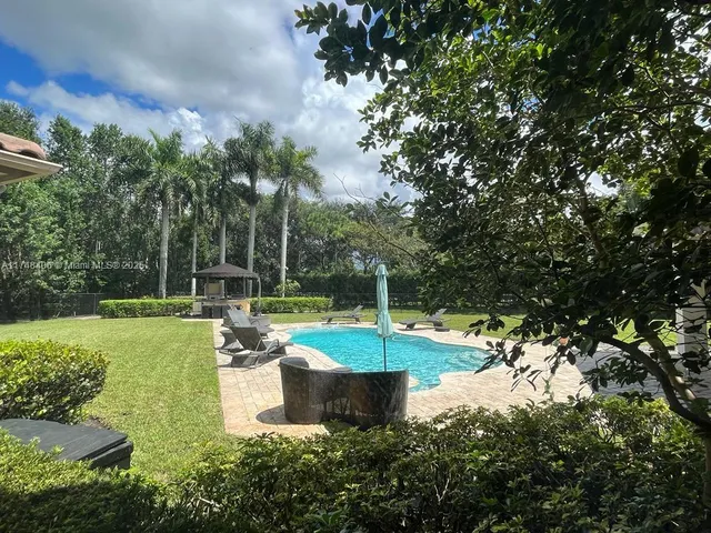 a spacious bathroom with a mirror sink and toilet