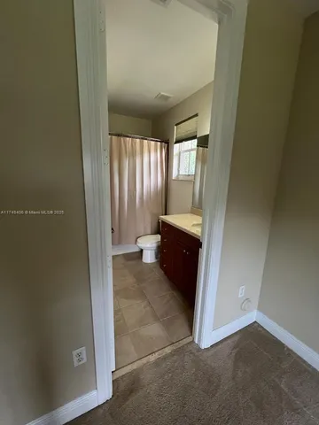 a view of a swimming pool with lawn chairs and a fire pit