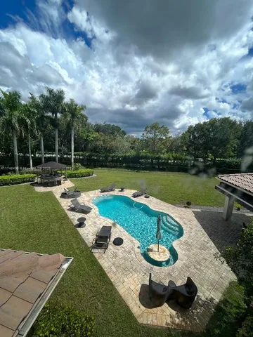 a view of a backyard with swimming pool