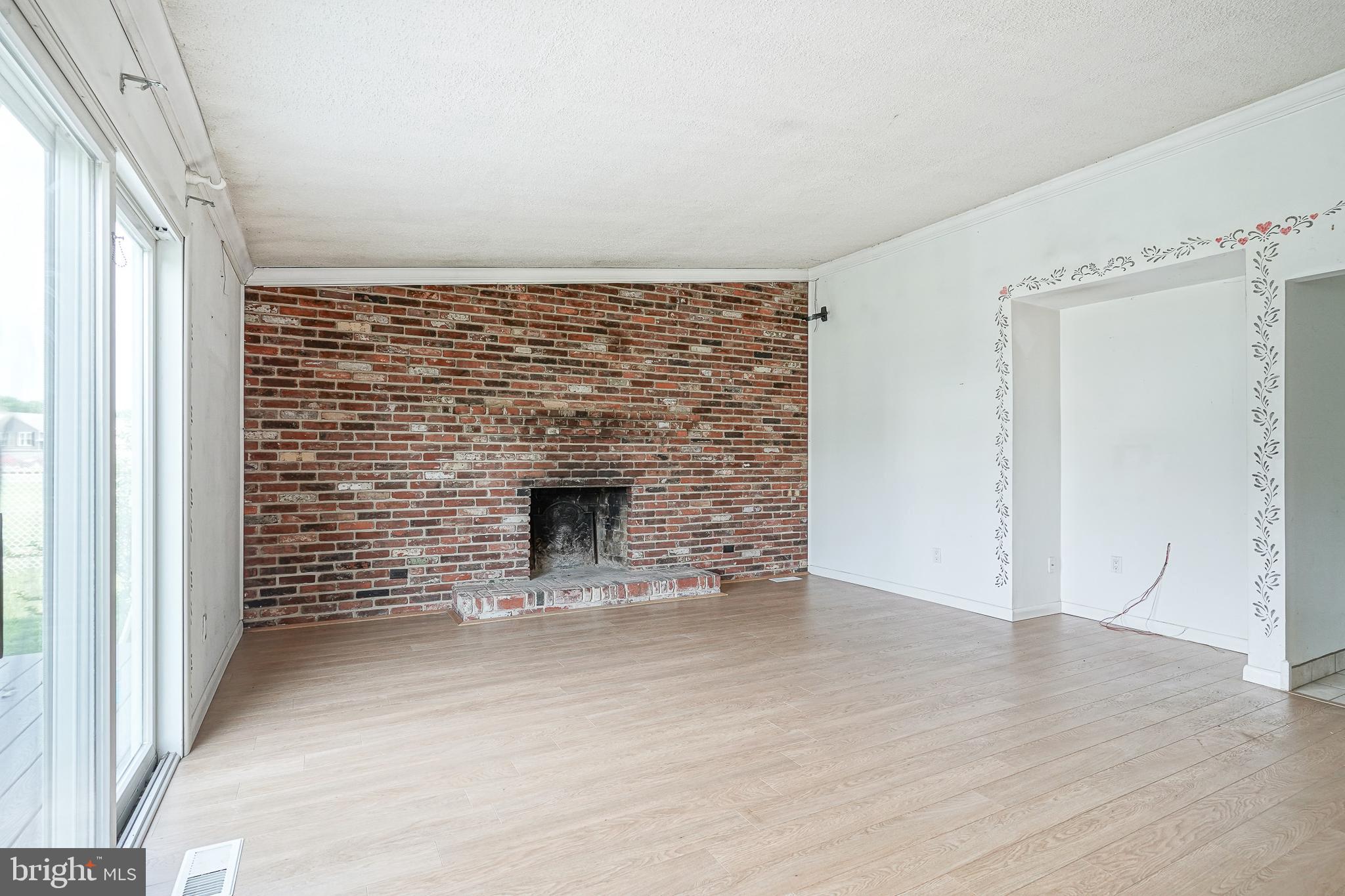 152 Kelly Driver Road Laurel Springs, NJ 08021 - Photo 14 of 30 an empty room with wooden floor and fireplace