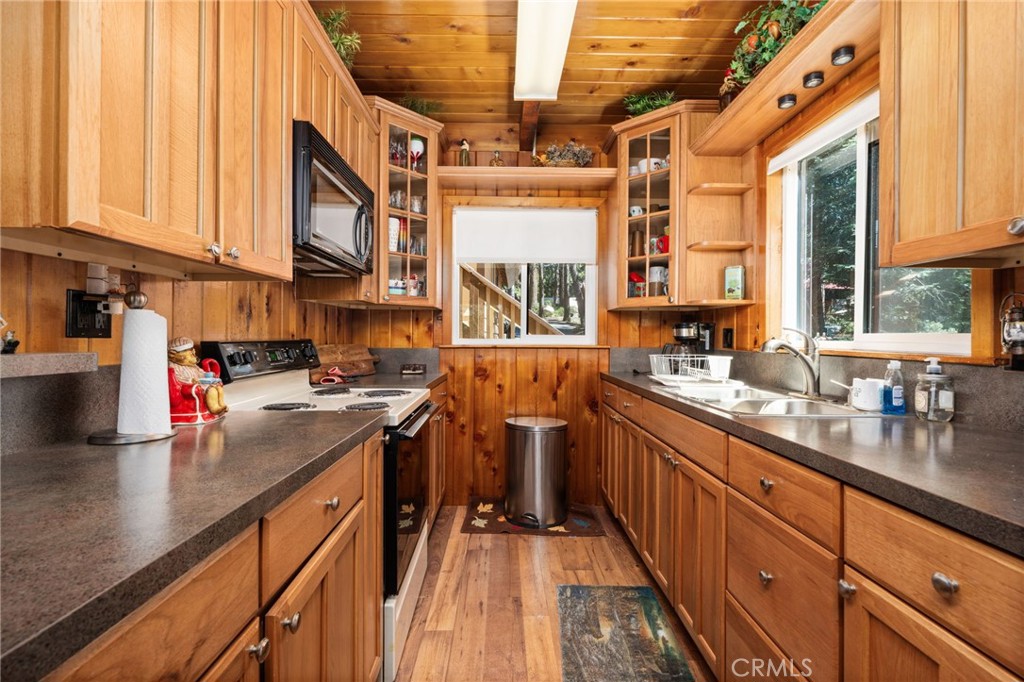 42031 North Aspen Road Shaver Lake, CA 93664 - Photo 15 of 49 a kitchen with stainless steel appliances granite countertop a lot of counter space and a sink