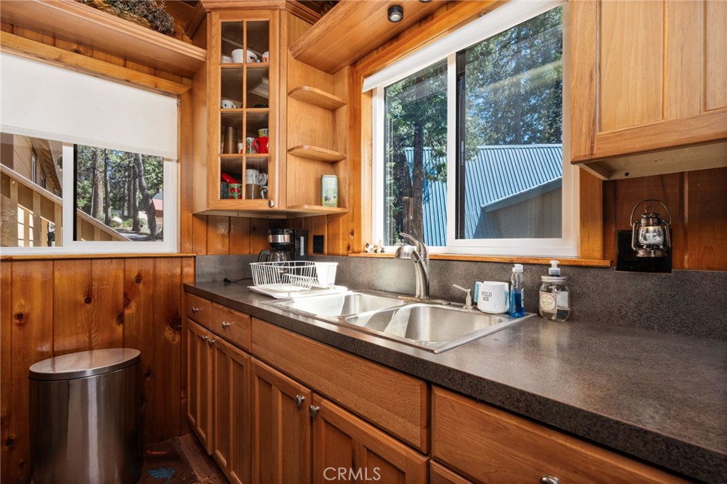 42031 North Aspen Road Shaver Lake, CA 93664 - Photo 17 of 49 a kitchen with stainless steel appliances a sink and a window