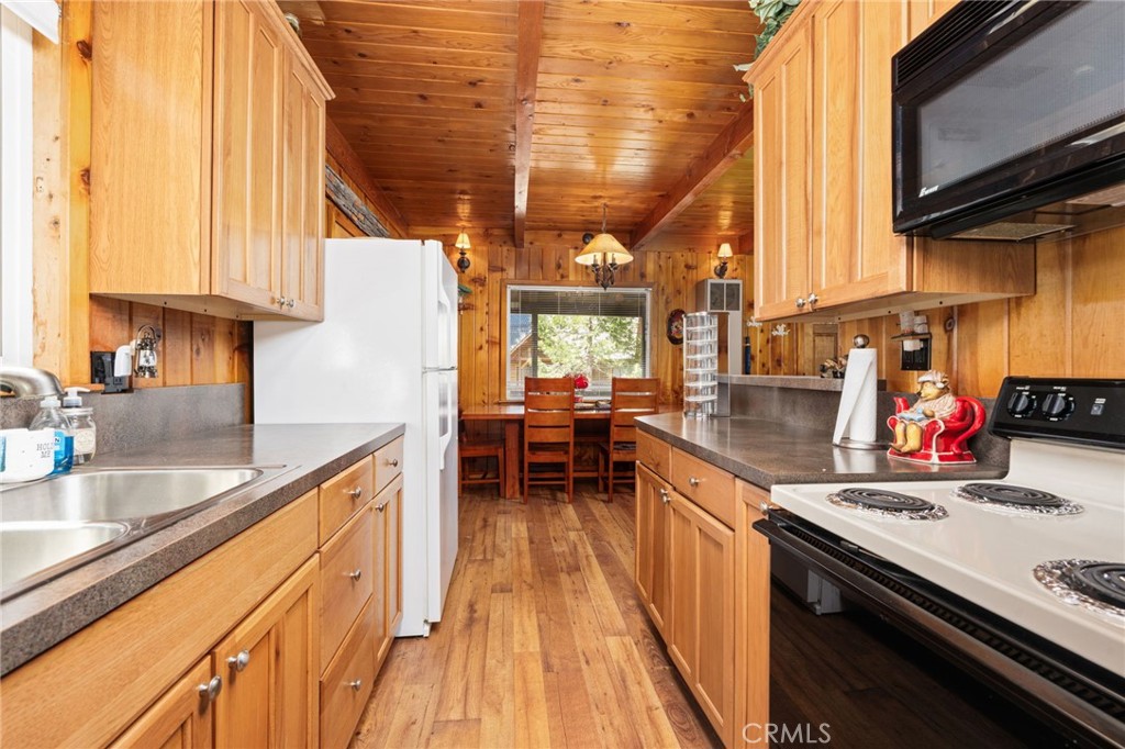 42031 North Aspen Road Shaver Lake, CA 93664 - Photo 18 of 49 a kitchen with a sink a stove and cabinets