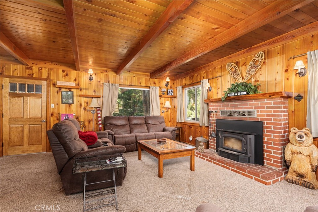 42031 North Aspen Road Shaver Lake, CA 93664 - Photo 19 of 49 a living room with furniture a fireplace and a table