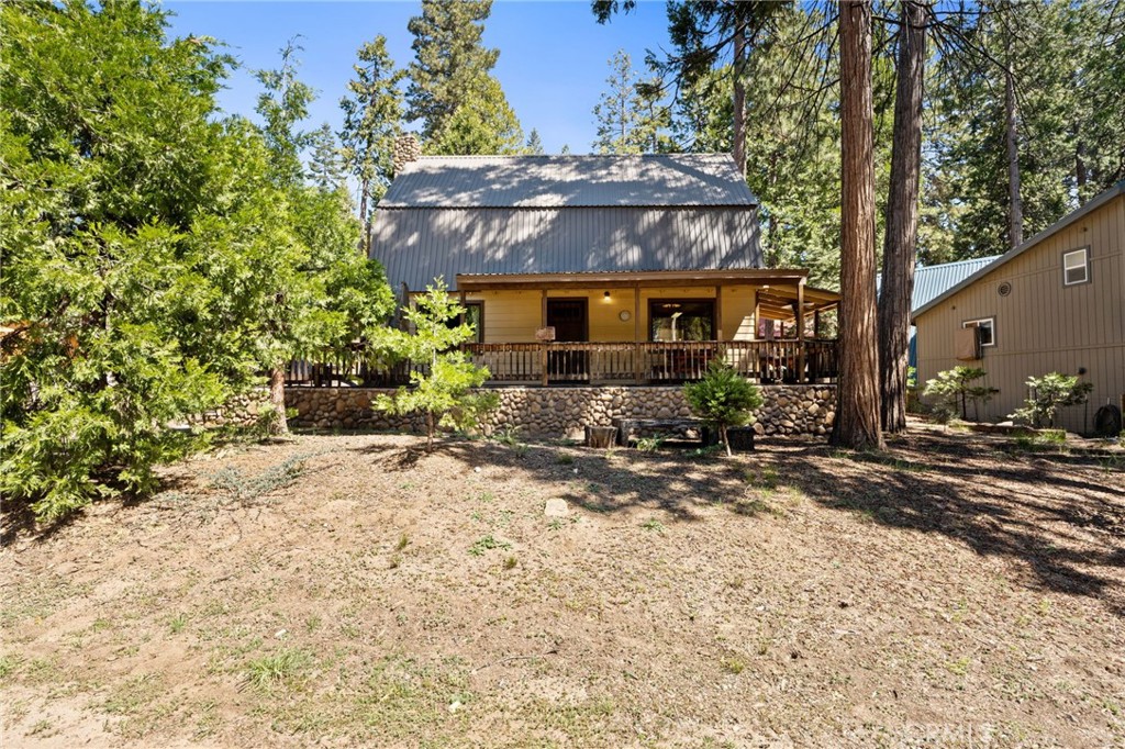 42031 North Aspen Road Shaver Lake, CA 93664 - Photo 2 of 49 a front view of house with yard and trees around