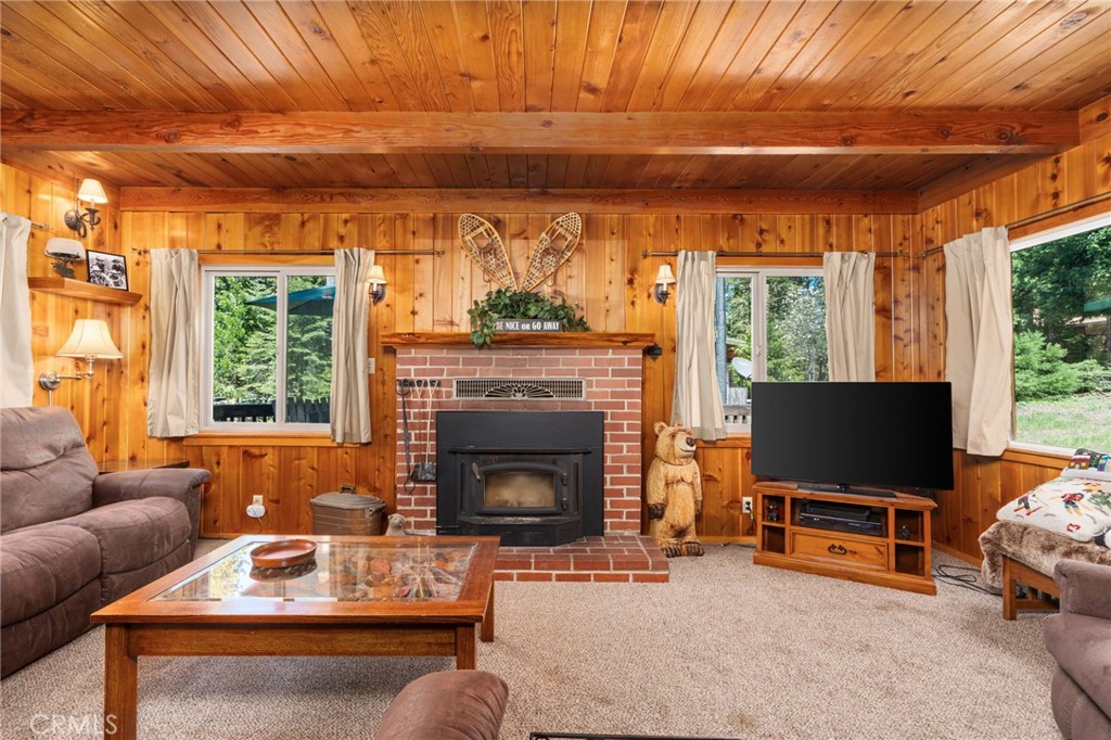 42031 North Aspen Road Shaver Lake, CA 93664 - Photo 22 of 49 a living room with furniture a flat screen tv and a fireplace