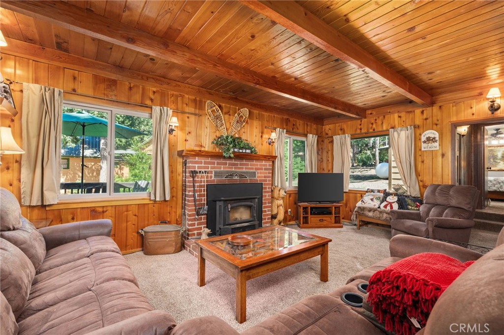 42031 North Aspen Road Shaver Lake, CA 93664 - Photo 23 of 49 a living room with furniture a flat screen tv and a fireplace