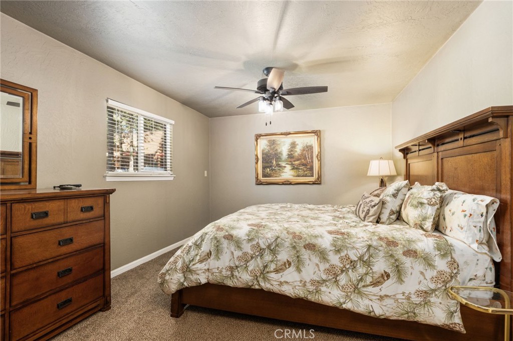 42031 North Aspen Road Shaver Lake, CA 93664 - Photo 25 of 49 a bedroom with a bed and a window