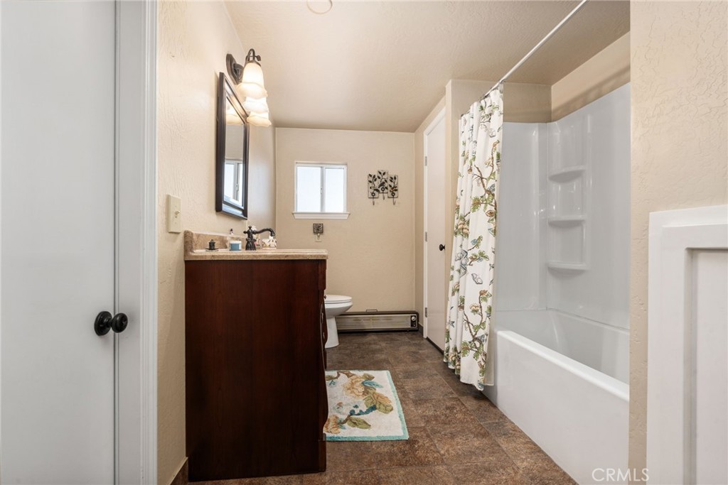 42031 North Aspen Road Shaver Lake, CA 93664 - Photo 27 of 49 a bathroom with a bathtub and shower