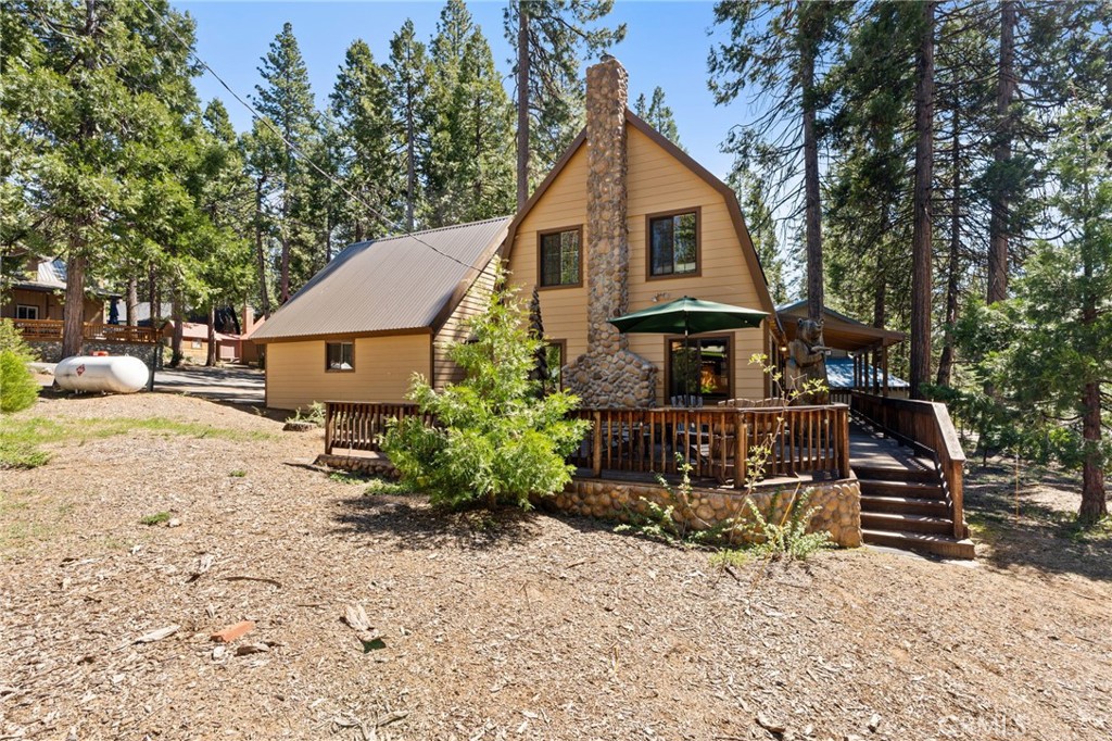 42031 North Aspen Road Shaver Lake, CA 93664 - Photo 3 of 49 a front view of a house with garden
