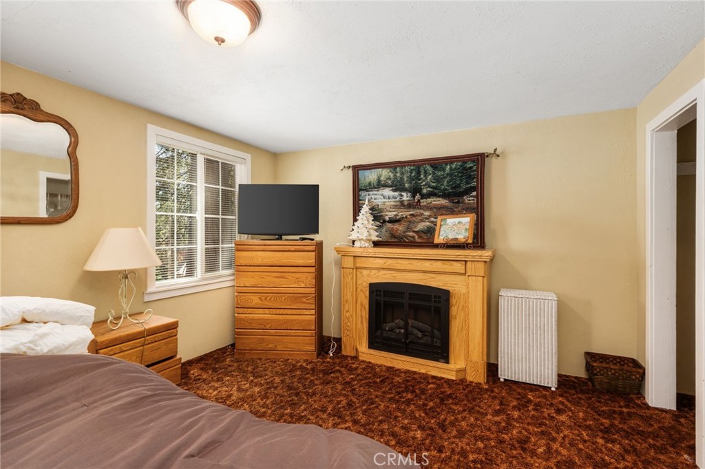 42031 North Aspen Road Shaver Lake, CA 93664 - Photo 33 of 49 a living room with furniture and a fireplace