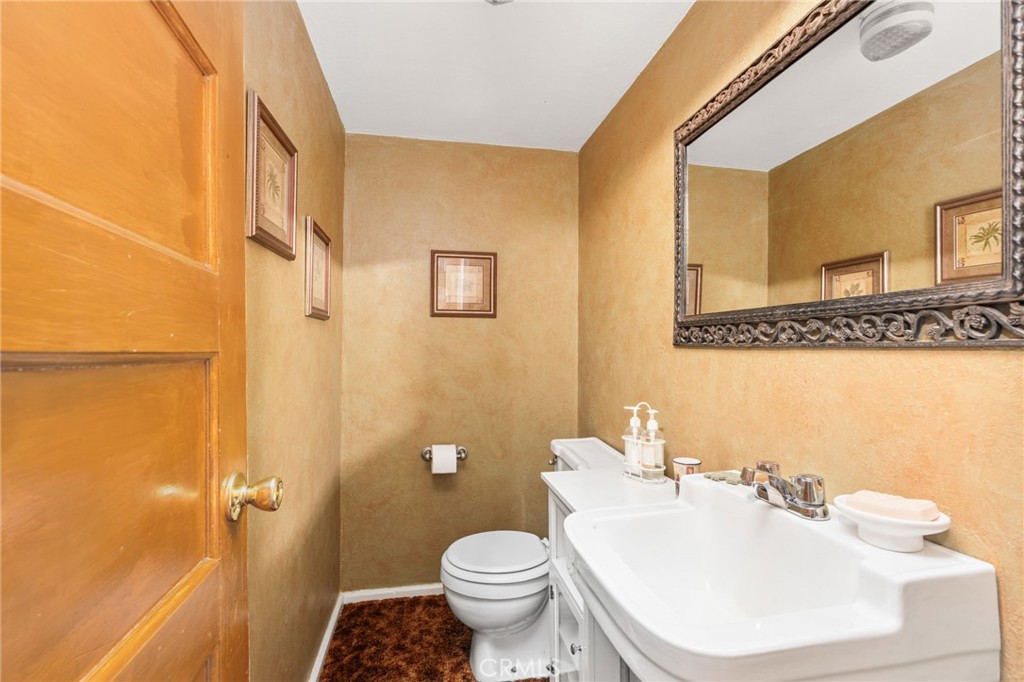 42031 North Aspen Road Shaver Lake, CA 93664 - Photo 34 of 49 a bathroom with a sink a toilet and shower curtain