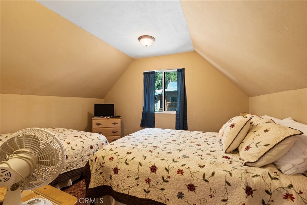 42031 North Aspen Road Shaver Lake, CA 93664 - Photo 37 of 49 a bedroom with two beds and a large mirror