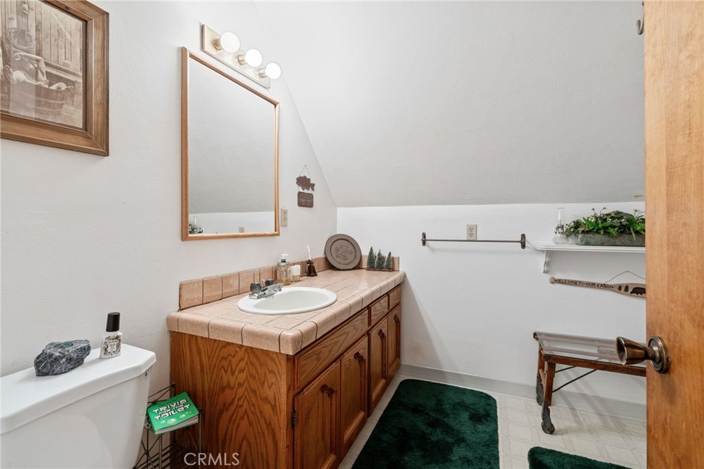 42031 North Aspen Road Shaver Lake, CA 93664 - Photo 39 of 49 a bathroom with a sink and a mirror
