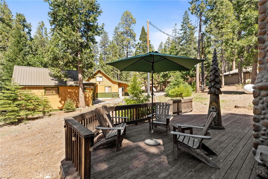 42031 North Aspen Road Shaver Lake, CA 93664 - Photo 43 of 49 a view of a patio with a table chairs and a barbeque
