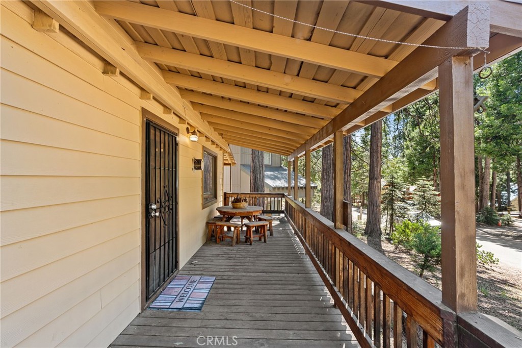42031 North Aspen Road Shaver Lake, CA 93664 - Photo 5 of 49 a view of a patio with chairs and wooden floor